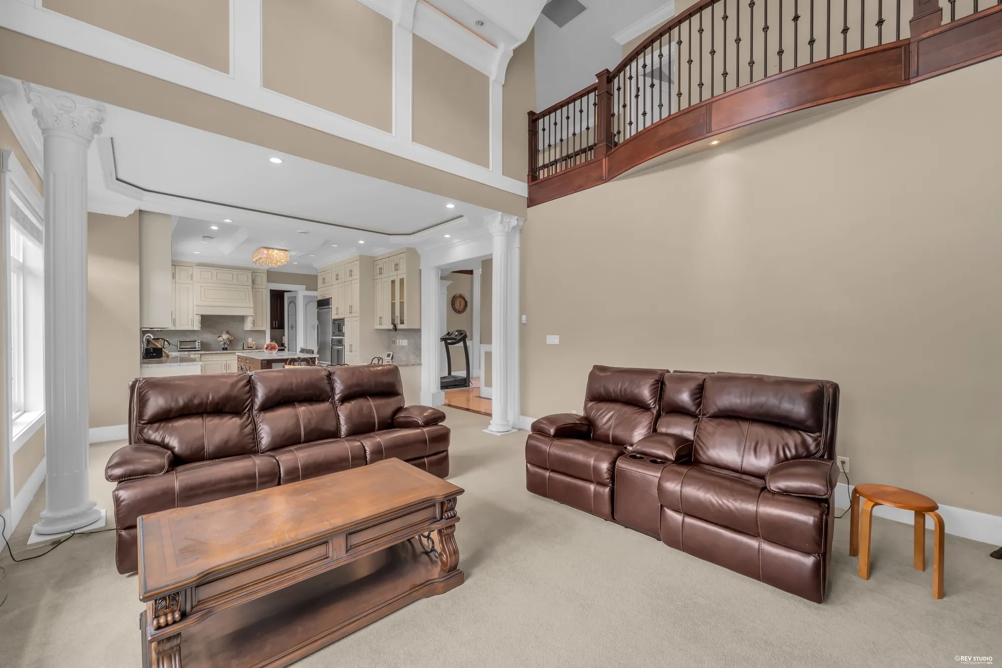 The family room under the gallery rail of the upper hall, the sofas facing each other