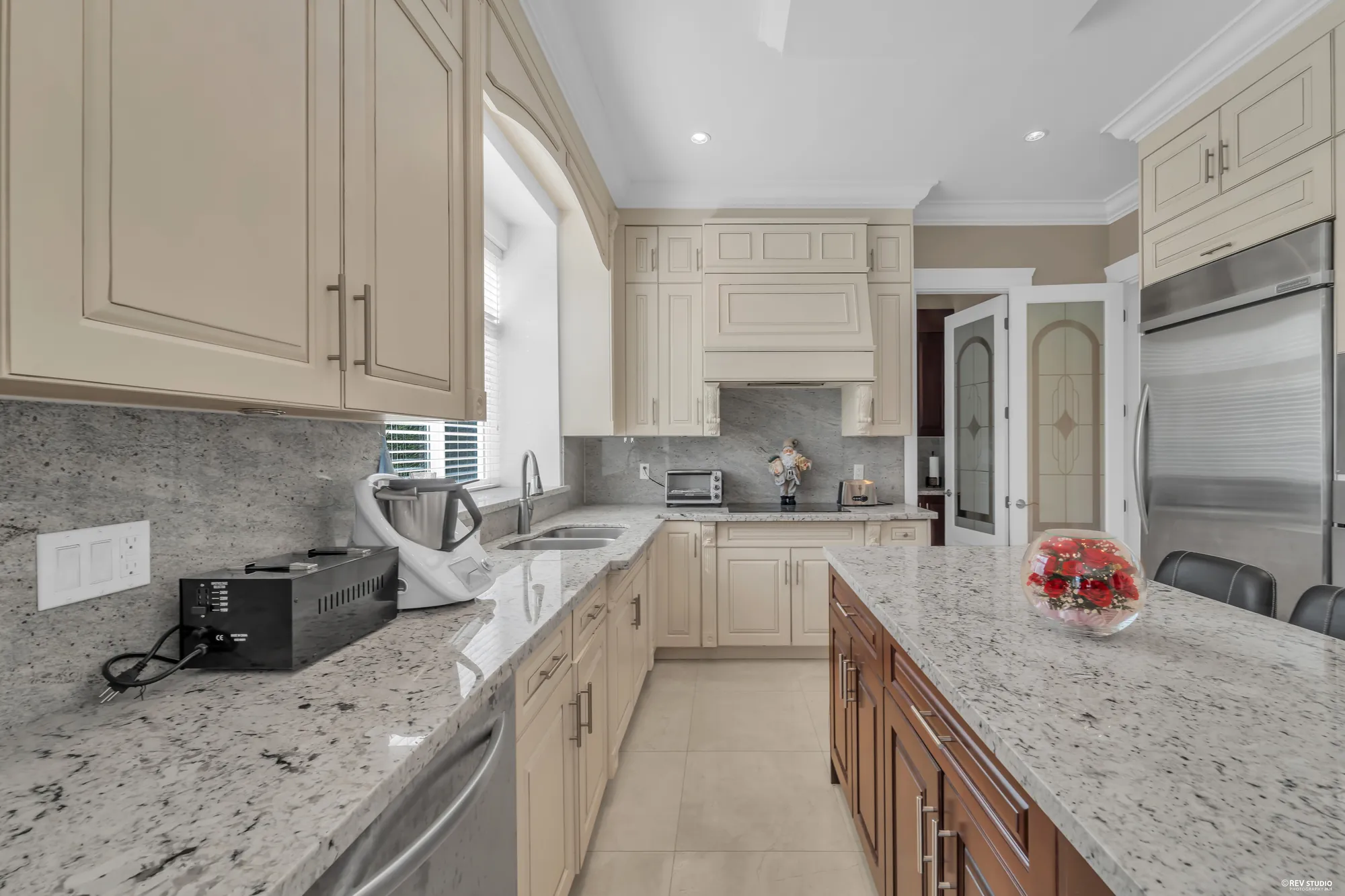 The long granite counter under the window, the island at right