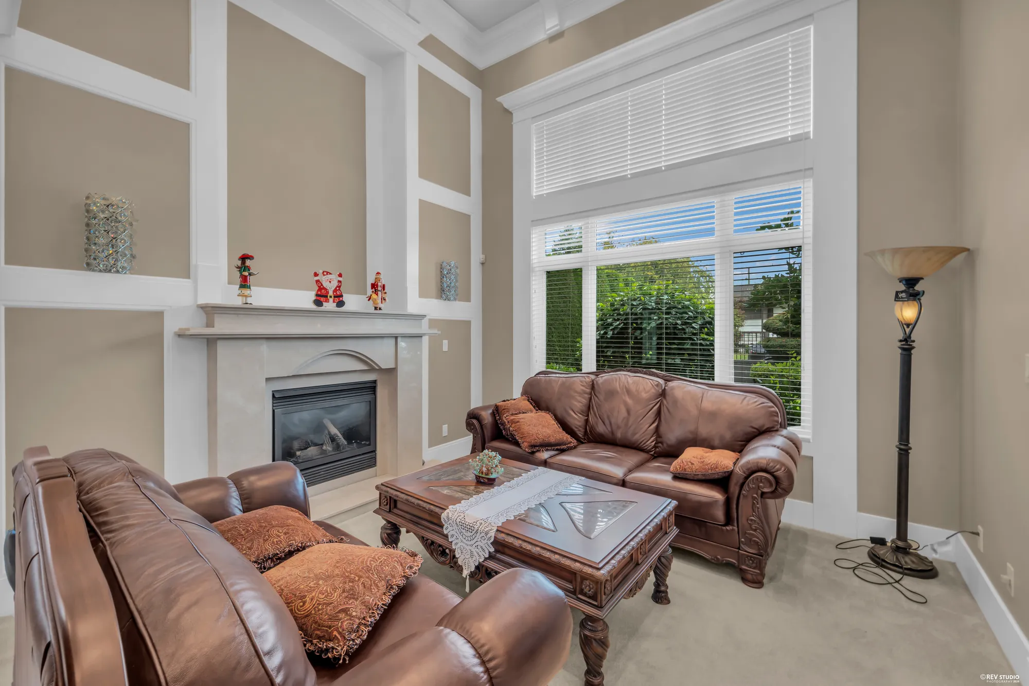 The living room toward its windows, the sofas around a carved table
