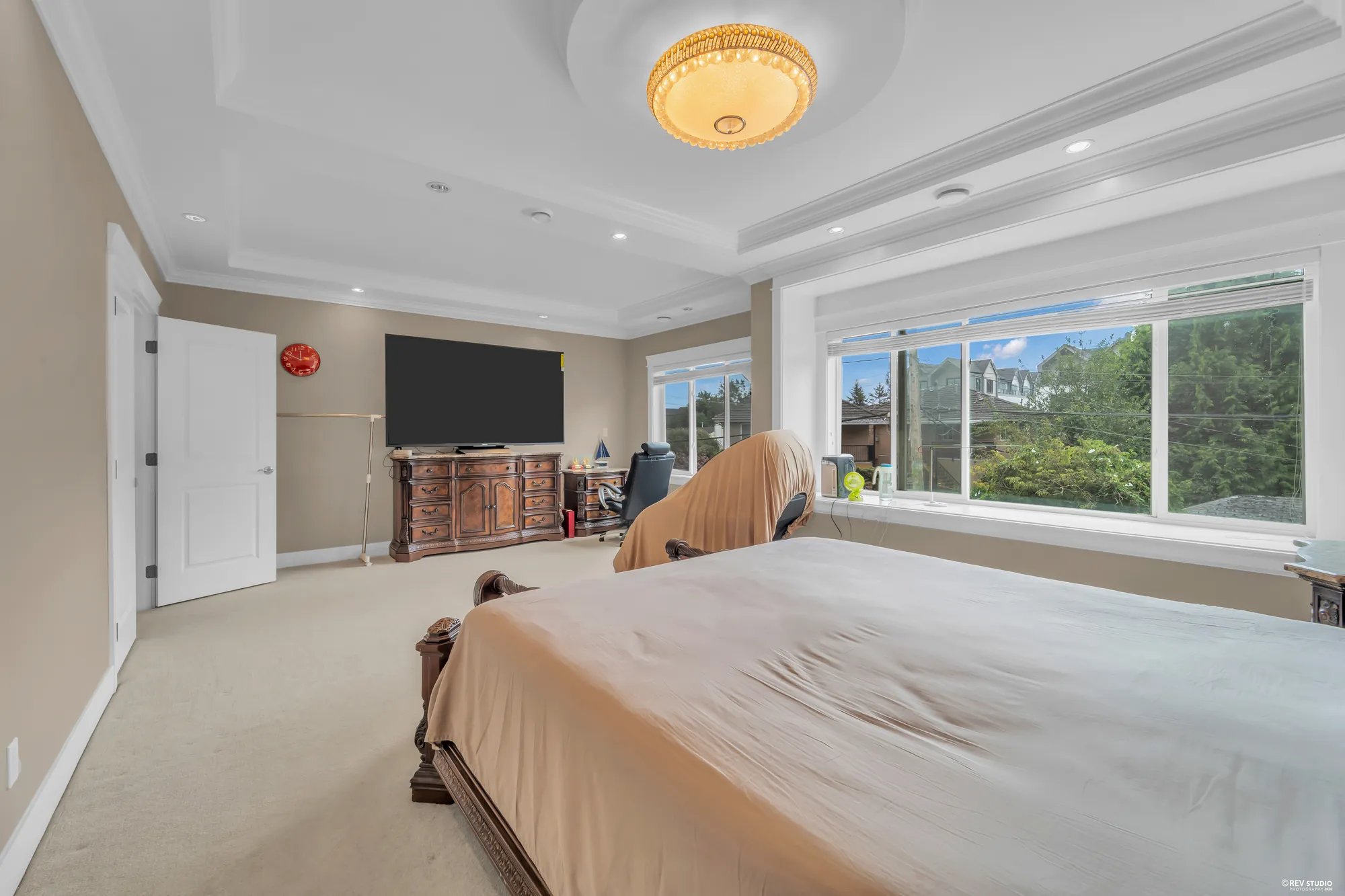 The primary bedroom toward the television and the door
